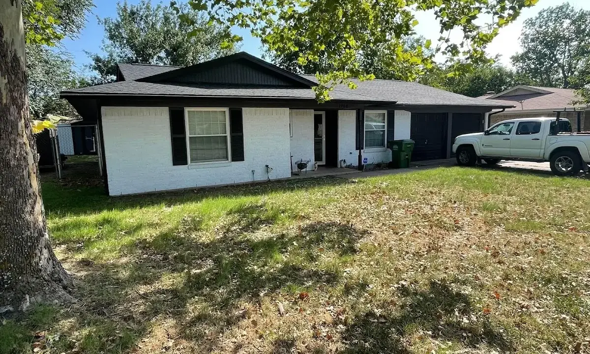 Professional roofing crew working on a residential roof in Mashpee